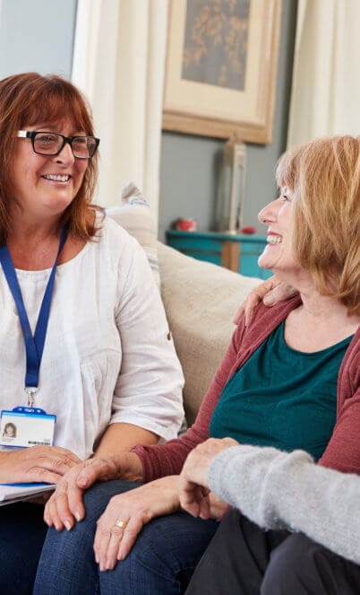 caregiver visits senior couple at home