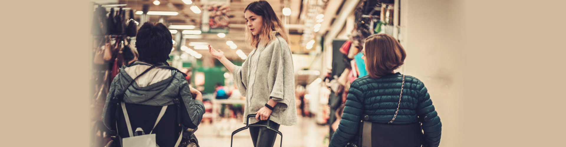 young girl helping two disabled women in wheelchair in a department store